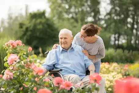 elderly person with caregiver spending time outside