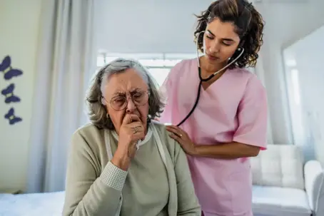 medical professional examining elderly woman at home