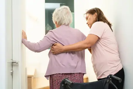 caregiver helping senior walk